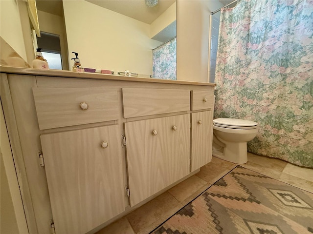 bathroom with a shower with shower curtain, toilet, tile patterned flooring, and vanity