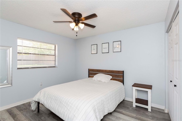 bedroom featuring hardwood / wood-style flooring, ceiling fan, a textured ceiling, and a closet