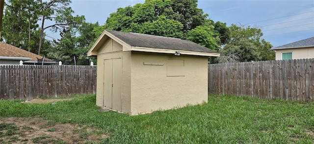 view of outbuilding featuring a yard