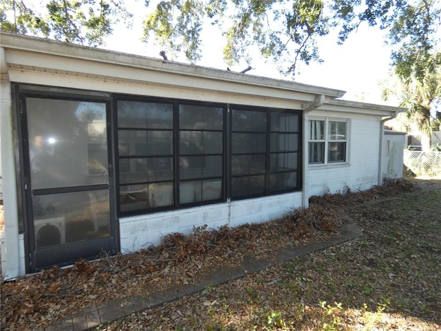 view of side of property featuring a sunroom