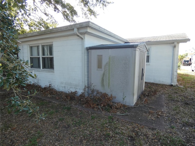 view of side of home with a storage unit