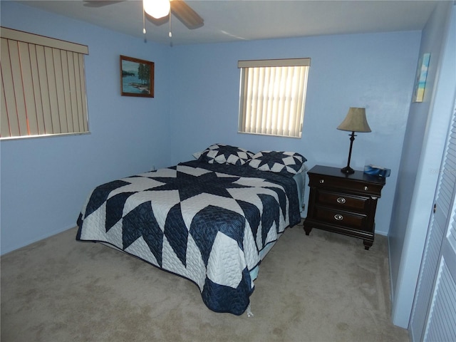 bedroom featuring ceiling fan and light carpet