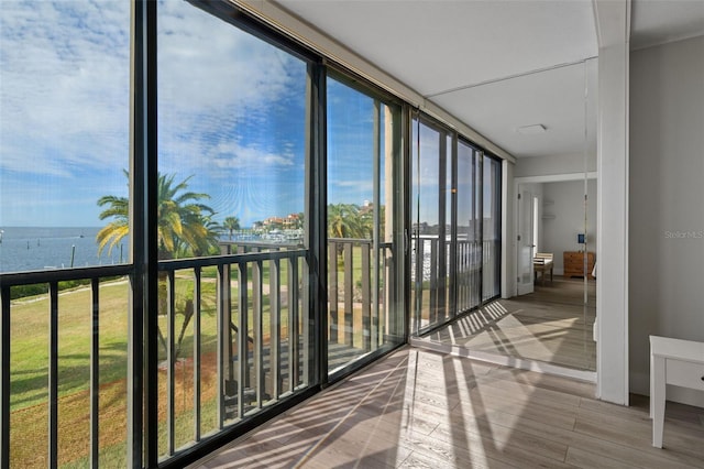 unfurnished sunroom with a water view