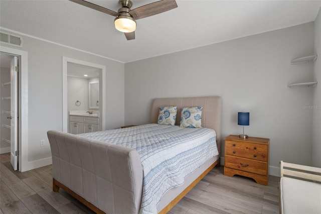 bedroom with connected bathroom, ceiling fan, and light hardwood / wood-style flooring