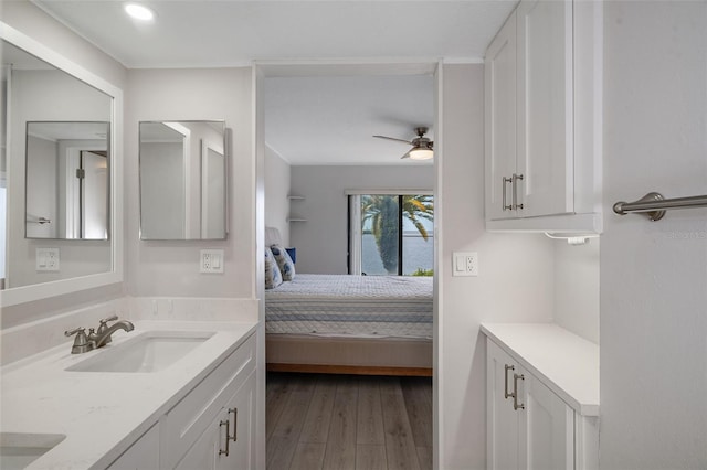 bathroom with wood-type flooring, vanity, and ceiling fan