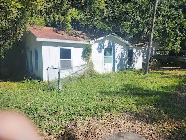 view of side of property with a yard