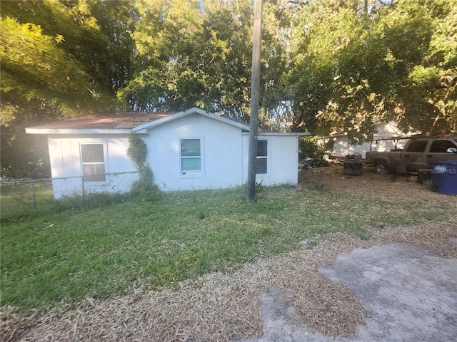 view of side of home with a yard