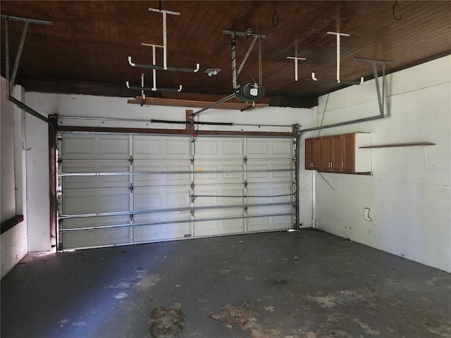 garage featuring a garage door opener and wood ceiling