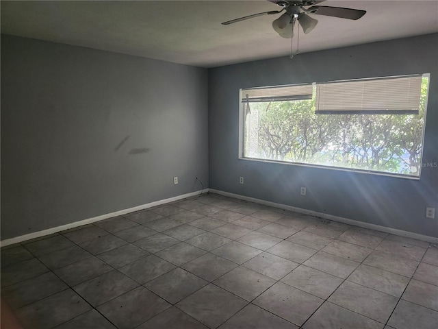 unfurnished room featuring ceiling fan and light tile patterned flooring