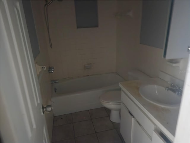 full bathroom featuring tile patterned floors, vanity, toilet, and tiled shower / bath combo