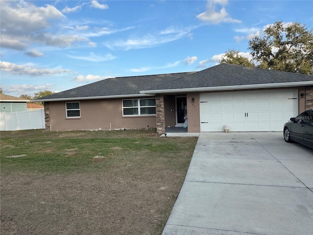 ranch-style house featuring a front yard and a garage