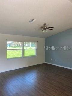 unfurnished room with dark hardwood / wood-style flooring, ceiling fan, and plenty of natural light