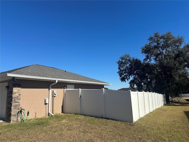 view of side of home featuring a lawn