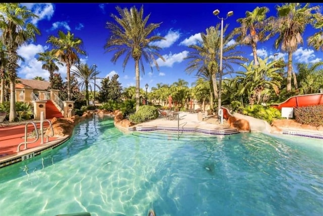 view of swimming pool with a water slide