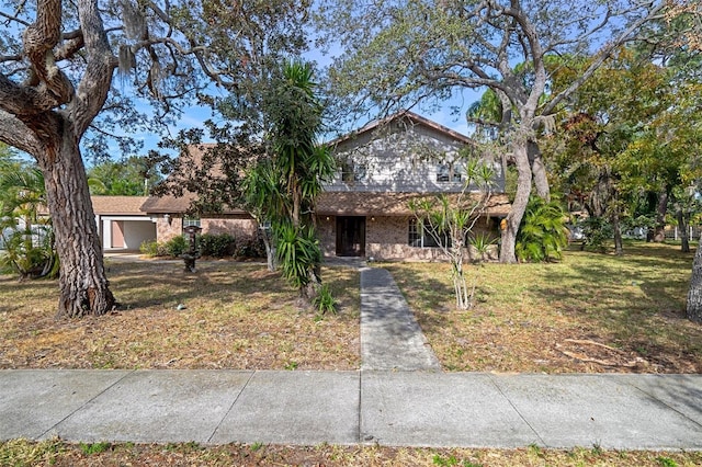 view of front of property with a garage and a front lawn