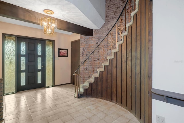 entrance foyer with beamed ceiling, light tile patterned floors, and an inviting chandelier