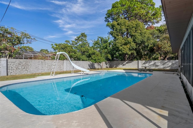 view of swimming pool featuring a patio area and a water slide