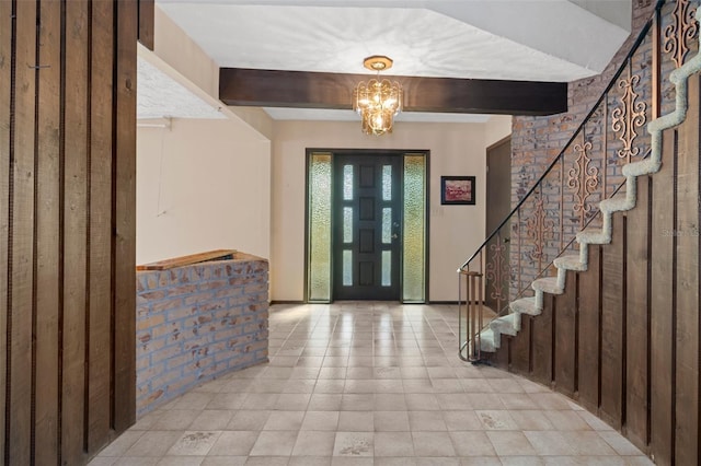 entrance foyer featuring beamed ceiling and a notable chandelier