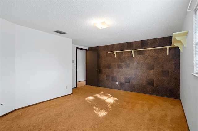 unfurnished bedroom featuring carpet and a textured ceiling