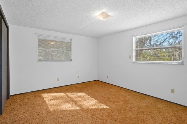 unfurnished bedroom featuring carpet and a textured ceiling