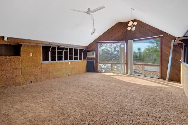 unfurnished living room with ceiling fan, an AC wall unit, carpet floors, and vaulted ceiling