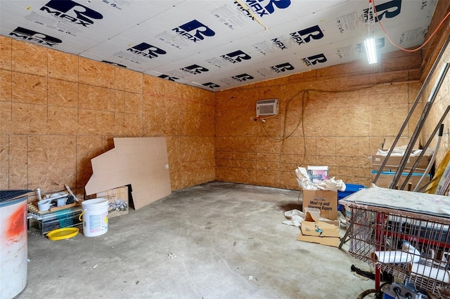 interior space with a wall mounted air conditioner and concrete floors