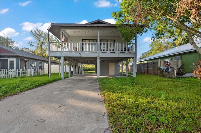 view of front of property with a front lawn and a carport