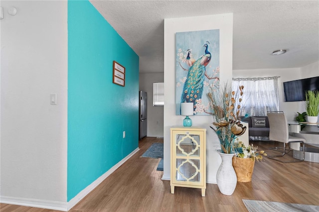 living room with hardwood / wood-style floors and a textured ceiling