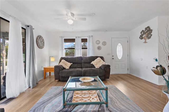 living room with ceiling fan and light hardwood / wood-style floors