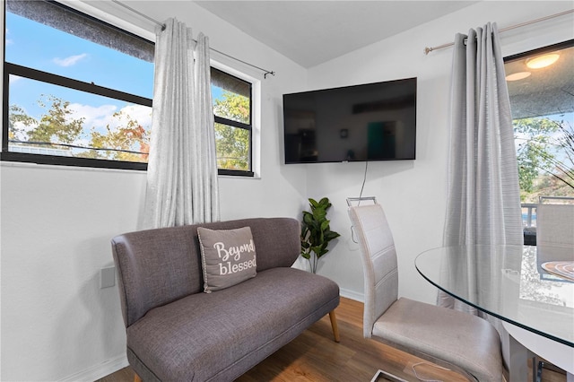 sitting room with lofted ceiling and wood-type flooring