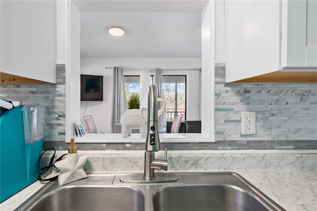 kitchen with white cabinets and tasteful backsplash