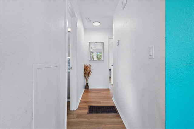 corridor featuring hardwood / wood-style floors