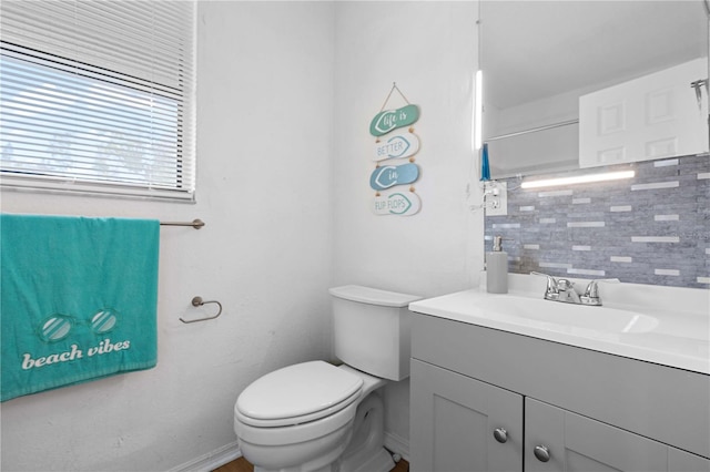 bathroom featuring decorative backsplash, vanity, and toilet