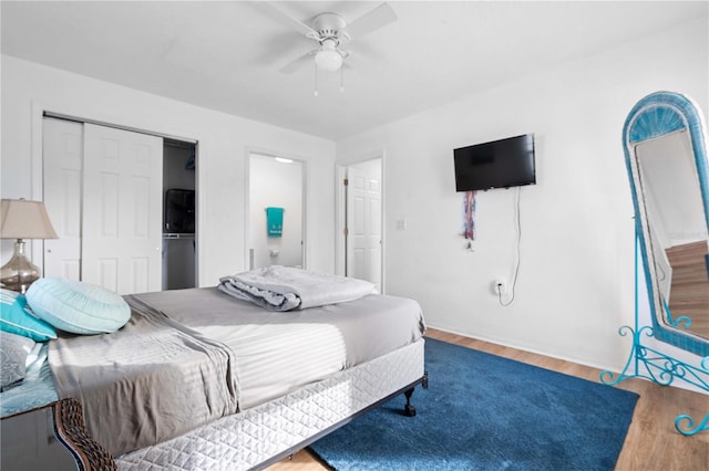 bedroom with hardwood / wood-style flooring, a closet, and ceiling fan