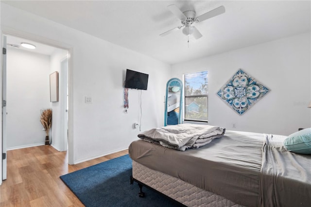 bedroom featuring light hardwood / wood-style flooring and ceiling fan