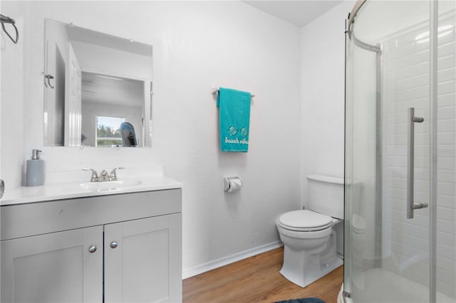 1244 31st Ave E, Bradenton, FL 34208 - full bathroom featuring vanity, a stall shower, and wood finished floors