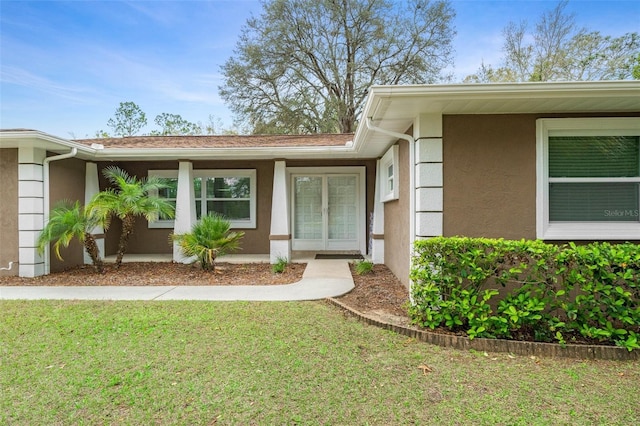 doorway to property with a yard