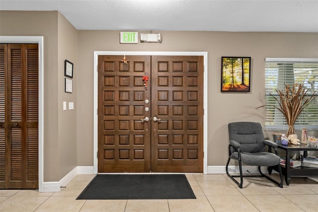 tiled foyer entrance with a textured ceiling