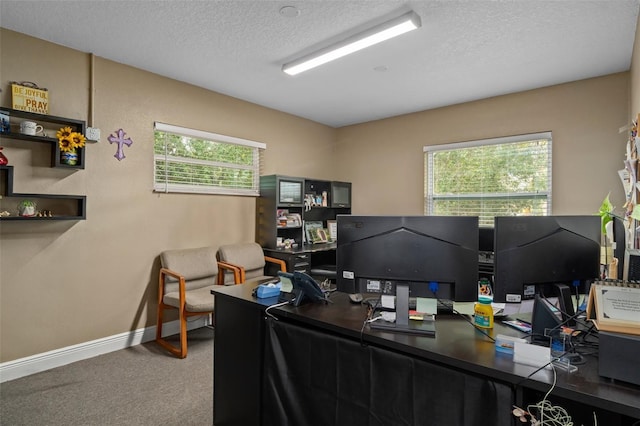 office area featuring carpet, plenty of natural light, and a textured ceiling