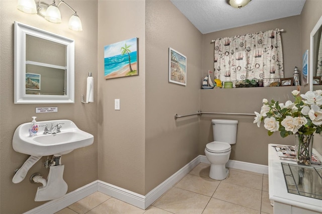 bathroom featuring sink, tile patterned flooring, a textured ceiling, and toilet