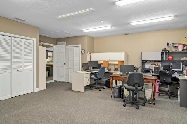 office area with light carpet and a textured ceiling