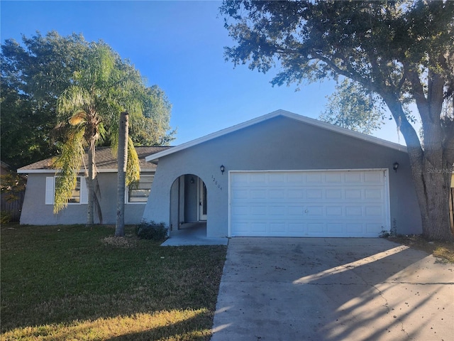 single story home featuring a garage and a front yard