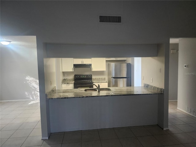 kitchen with stone countertops, stainless steel refrigerator, sink, white cabinets, and black range with electric stovetop