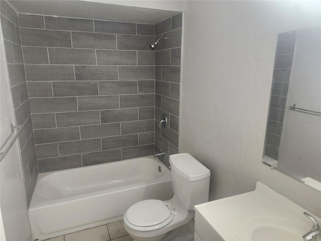 full bathroom featuring tile patterned flooring, vanity, toilet, and tiled shower / bath