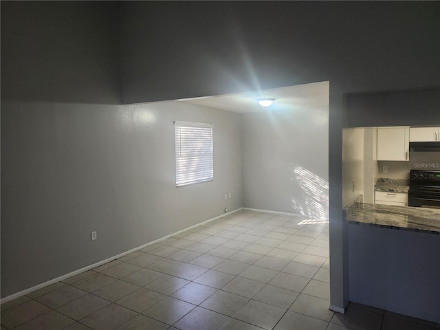 unfurnished room with light tile patterned floors