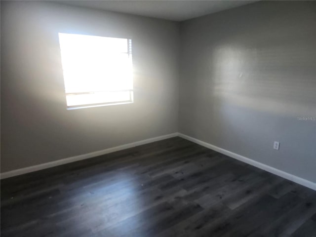 empty room with dark wood-type flooring