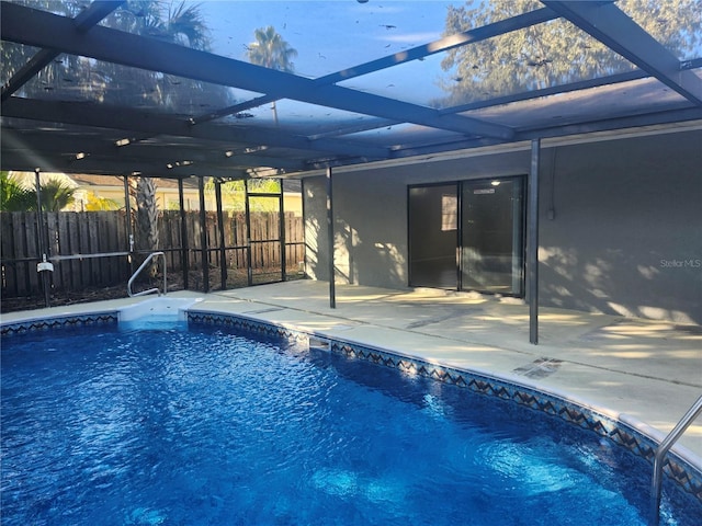 view of swimming pool with a lanai and a patio