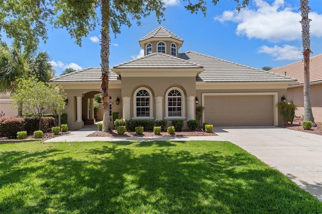 mediterranean / spanish-style house with a front yard and a garage