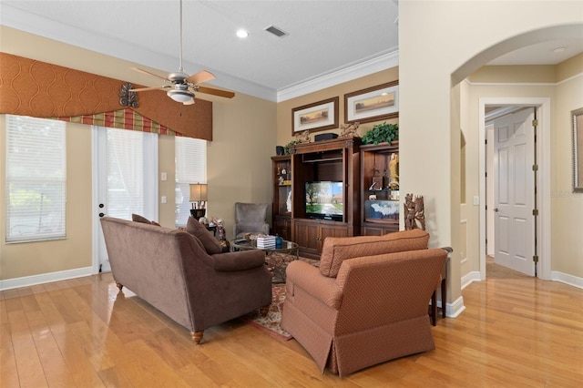 living room with ceiling fan, light hardwood / wood-style floors, and crown molding