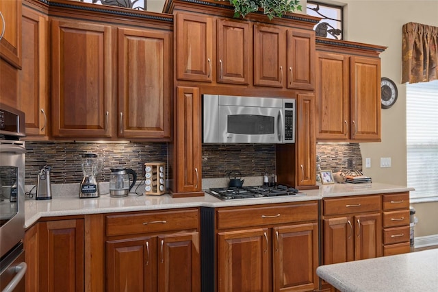 kitchen with decorative backsplash and appliances with stainless steel finishes